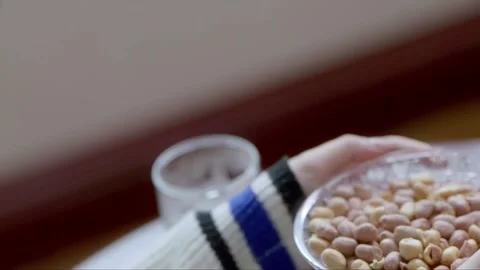 Pick up a plate of peanuts Stock Footage 261641852
