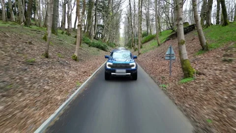 Pick up truck driving through forest front shot aerial generic unmarked aerial Stock Footage 276894267
