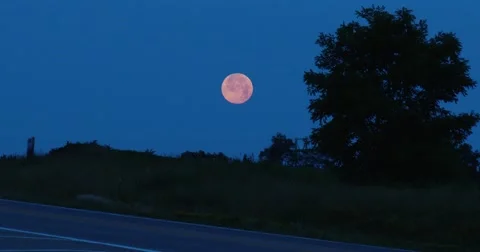 Pick Up Truck  Passes in front of Full / Red Moon - 4k Stock Footage 64997196