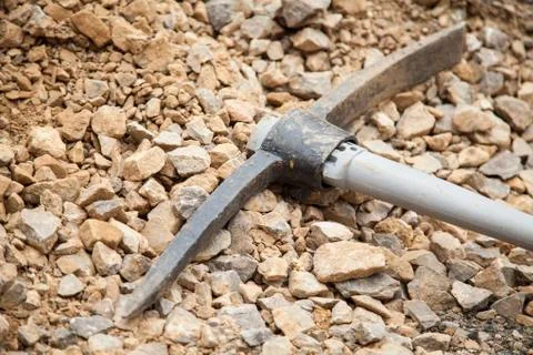 Pickaxe on rubble Stock Photos