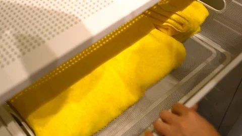 Picked up small towel placed on large before closing drawer Stock Footage 79390095