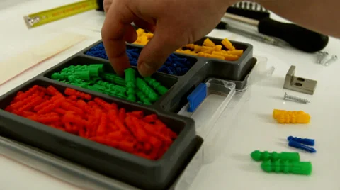 Picking and choosing plastic screws Stock Footage 38286250