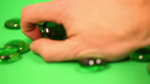 Picking Up and Dropping Green Gems Stock Footage 57750779