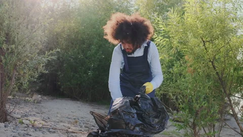 Picking-Up and Packing Plastic Garbage in Refuse Sack. Concept of Reuse and Stock Footage 148186500