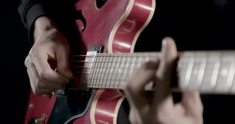 Picking and playing on individual guitar strings 스톡 동영상 101682736