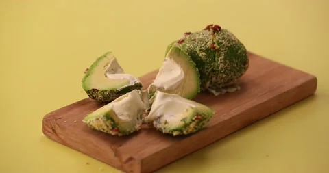 Picking up an avocado and eating it 2 스톡 동영상 132136395
