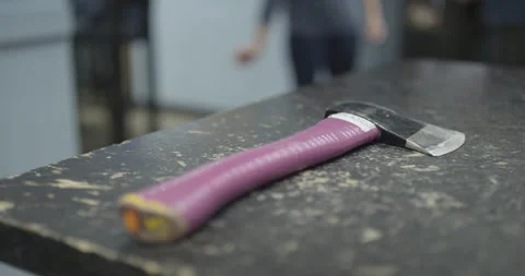 Picking up an axe at an axe throwing game Stock Footage 137823203