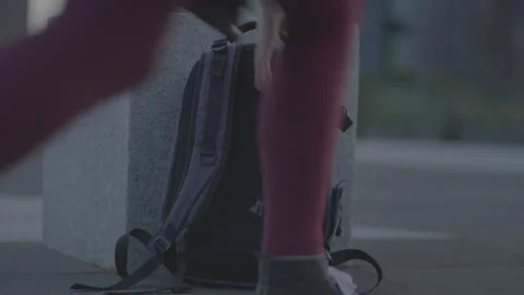 Picking up a backpack from the floor and leaving Stockbeeldmateriaal 199953498