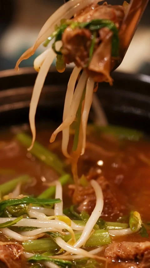 Picking Beef and Vegetables from Thai Hot Pot Soup with Chopsticks Video stock 346737814