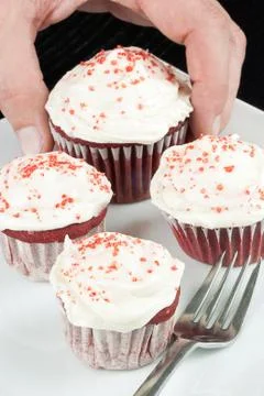 Picking the biggest cupcake Stock Photos