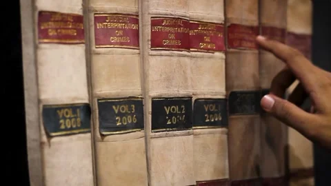 Picking up a book from Library Stock Footage 132648509