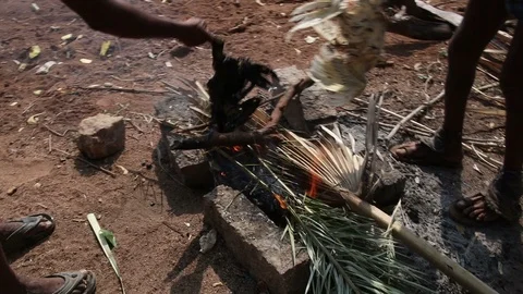 Picking-chicken-feathers-over-fire Stock Footage 109325984
