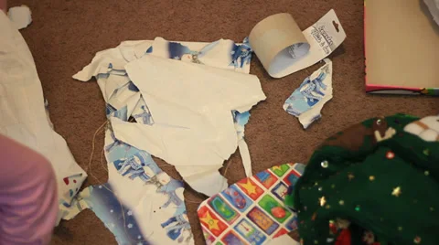 PICKING UP CHRISTMAS WRAPPING PAPER Stock Footage 33689218