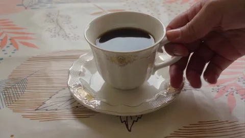 Picking up a cup of coffee Video stock 293242123