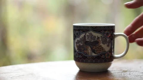 Picking up the cup of hot tea Stock Footage 57052671