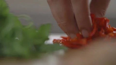 Picking up diced tomatoes Stock Footage 194478423