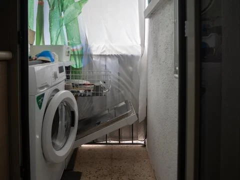 Picking up the dishwasher in the kitchen Stock Photos