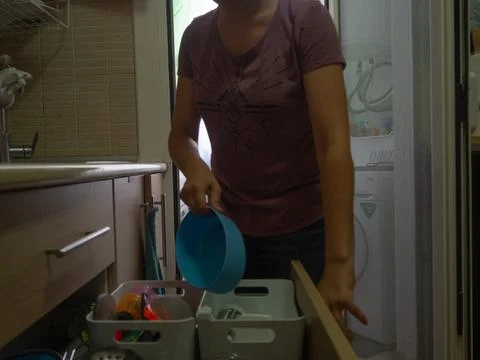 Picking up the dishwasher in the kitchen Stock Photos