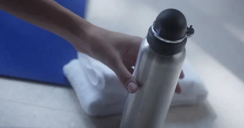 Picking up drinking bottle Stock Footage 172109441