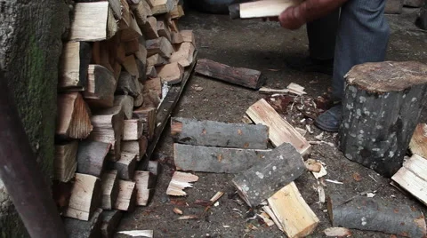 Picking up firewood from a stack of dry wood, strong man hands, firing Stock Footage 41265713