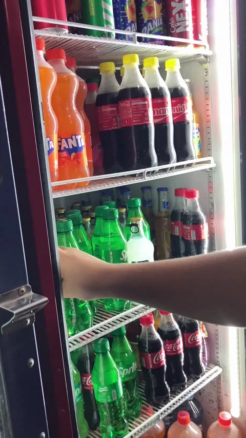 Picking up fizzy drinks from a refrigerator Stock Footage 328037071
