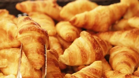 Picking Up A Fresh, Flaky, Croissant For Breakfast, At A Restuarant In The UK Stock Footage 274440754