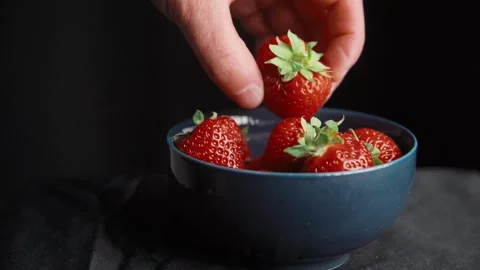 Picking up fresh strawberry from bowl in close up Stock Footage 344692135