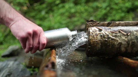 Picking up garbage water plastic nature. Volunteer cleaning river trash Stock Footage 249377733