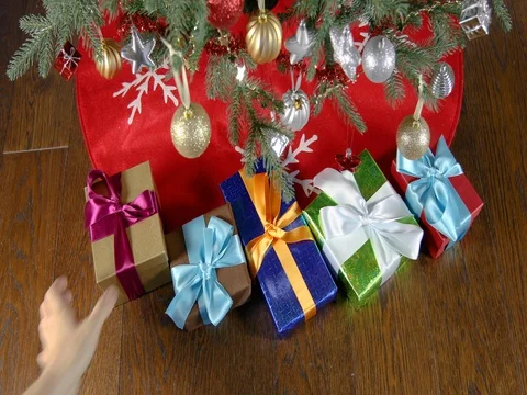 Picking gift boxes under christmas tree Stock Footage 73090944