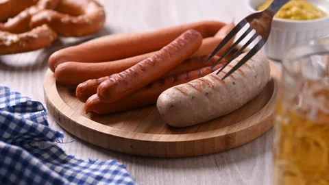 Picking up a grilled sausage with a fork from a plate Stock-Footage 342596766
