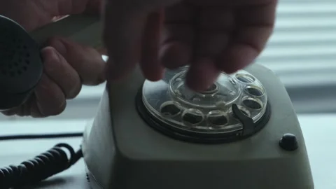 Picking up handset and dialing number on an old disk phone, closeup. Stock Footage 307993683