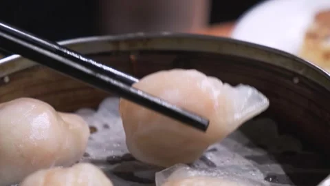Picking up Har Gao (dim sum shrimp dumpling) with chopsticks 2 스톡 동영상 257423435