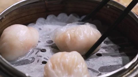 Picking up Har Gao (dim sum shrimp dumpling) with chopsticks 1 스톡 동영상 257423572