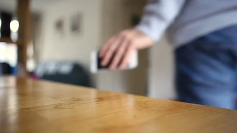 Picking up an IPhone &amp; leaving room Stock Footage 98061092