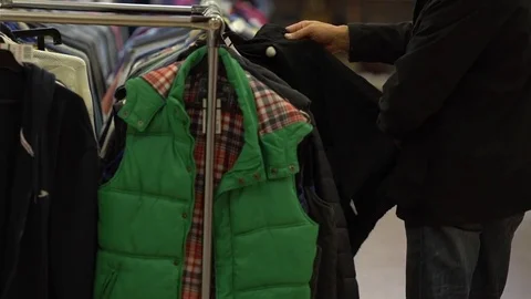 Picking a jacket in a shop Stock Footage 80735076