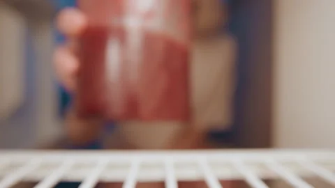 Picking up jam jar in kitchen. Closeup of red jam in glass with background blur Stock Footage 337462500