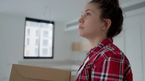 Picking up last boxes before moving out of her apartment young woman is sad Stock Footage 276720357