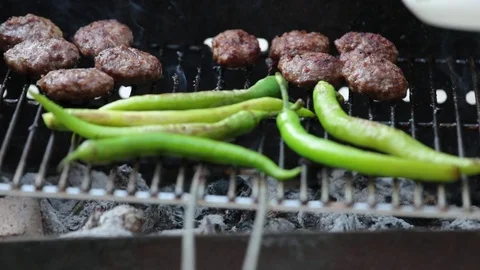Picking up a meatball from barbecue grill Stock Footage 92572299