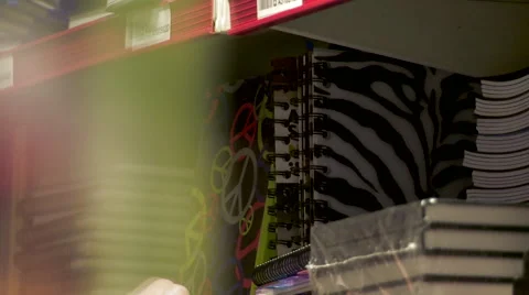 Picking a Notebook from a Shelf Stock Footage 62679978