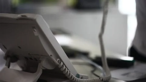 Picking up an old school phone in an office Stock Footage 211806246