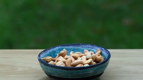 Picking out cashews to eat quickly with copy space and a shallow depth of fie Stock Footage 94594623