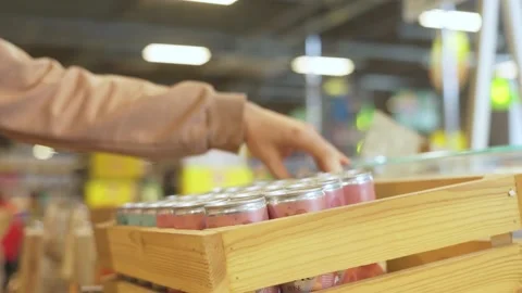 Picking out a tin can of beverage at the supermarket Stock Footage 221499694