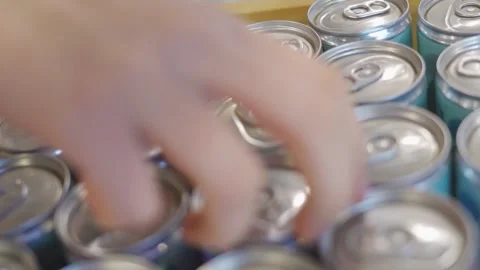Picking out a tin can of beverage at the supermarket Stock Footage 221499788