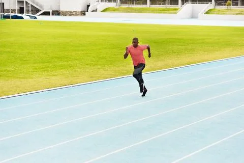 Picking up the pace. Full length shot of a handsome young male athlete running Stock Photos