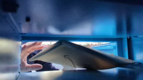 Picking up a package seen from inside a blue locker of a well-known  brand Stock Footage 268742284