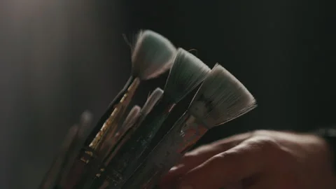 Picking Up a Paint Brust in a Moody Studio Closeup Video stock 312478264