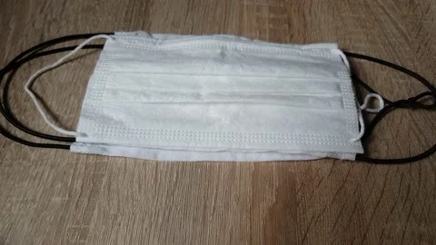 Picking Up A Piece Of Mask On The Table During Coronavirus Stock Footage 130400859