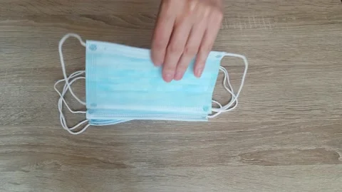 Picking Up A Piece Of Mask On The Table During Coronavirus Stock Footage 136957527