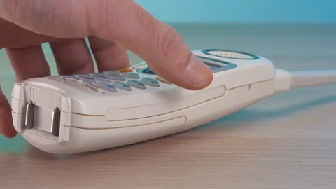 Picking Up a Retro 90s Phone Receiver Stock Footage 104874470