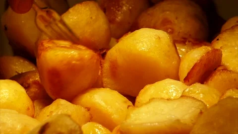 Picking Up Roast Potatoes Stock Footage 134940172